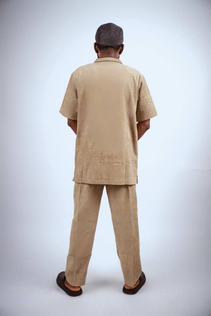 Man in a tan crinkle shirt and trouser set
