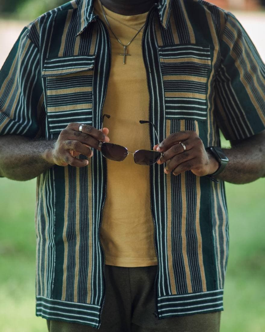 Man in a green striped aso-oke zip shirt