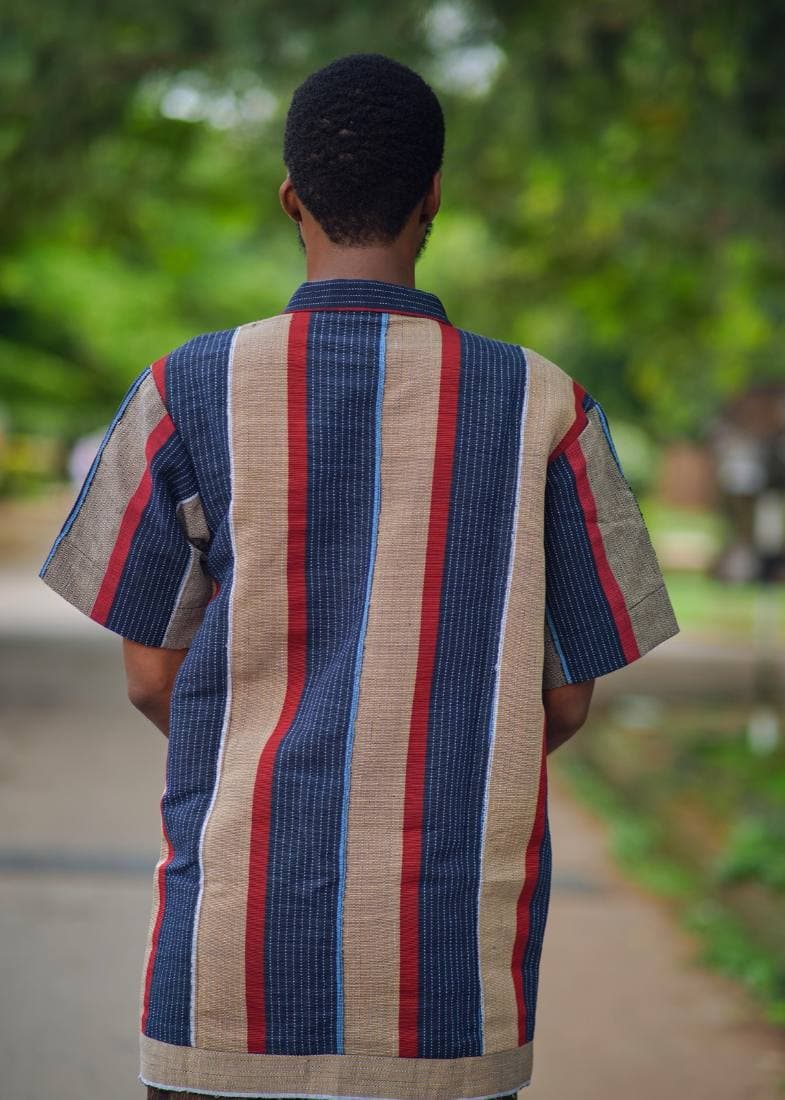 Man in an indigo and red aso-oke zip shirt