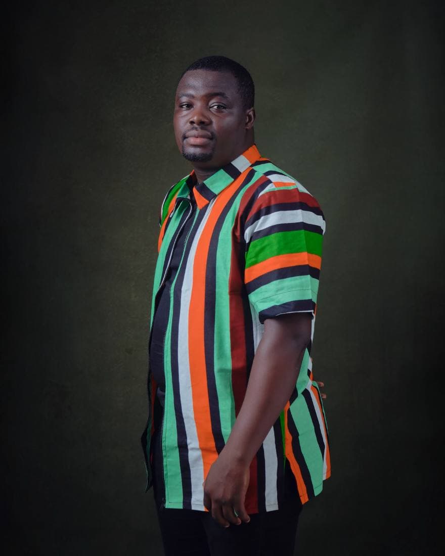Man in a multicolour striped aso-oke zip shirt